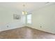 Bright dining area featuring a chandelier, neutral walls, and a large window providing ample natural light at 4817 Quarryman Rd, Raleigh, NC 27610