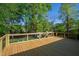 Wooden back deck overlooking the lush backyard and a shed at 4902 Brookhaven Dr, Raleigh, NC 27612