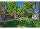 Landscaped backyard including a deck, patio, firepit and shed at 4902 Brookhaven Dr, Raleigh, NC 27612