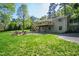 Wide shot of backyard featuring a deck, patio, and a fire pit at 4902 Brookhaven Dr, Raleigh, NC 27612