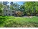 Lush backyard with a deck, patio, firepit, and storage shed at 4902 Brookhaven Dr, Raleigh, NC 27612