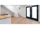 Basement area with a sink, stairs, and double glass doors at 4902 Brookhaven Dr, Raleigh, NC 27612