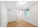 Finished basement room with wood-look flooring, closet and view to another room at 4902 Brookhaven Dr, Raleigh, NC 27612