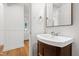 Bathroom features wood vanity, a stylish mirror, and paneled walls at 4902 Brookhaven Dr, Raleigh, NC 27612