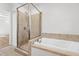 Bathroom with walk-in shower and separate soaking tub with tile surround at 4902 Brookhaven Dr, Raleigh, NC 27612