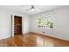 Bedroom featuring hardwood floors, a window, and a closet for storage at 4902 Brookhaven Dr, Raleigh, NC 27612