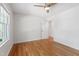 Bedroom featuring hardwood floors, a window, and a door to another room at 4902 Brookhaven Dr, Raleigh, NC 27612