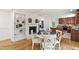 Charming dining area open to kitchen features a brick fireplace, and wood floors at 4902 Brookhaven Dr, Raleigh, NC 27612