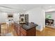 Dining area with white table, white chairs, natural lighting, and access to a backyard deck at 4902 Brookhaven Dr, Raleigh, NC 27612