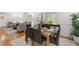 Open-concept dining room with hardwood floors, stylish decor, and large windows at 4902 Brookhaven Dr, Raleigh, NC 27612
