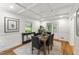 Elegant dining room with coffered ceilings, hardwood floors, and a view of the backyard at 4902 Brookhaven Dr, Raleigh, NC 27612
