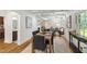 Dining room with hardwood floors, a view into the living room, and stylish decor at 4902 Brookhaven Dr, Raleigh, NC 27612