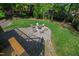 Cozy backyard fire pit area surrounded by mature trees at 4902 Brookhaven Dr, Raleigh, NC 27612