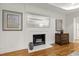 Elegant fireplace with decorative mirror, mantel and hardwood floors at 4902 Brookhaven Dr, Raleigh, NC 27612
