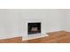 Bright fireplace features a white mantle with wood-burning insert and a stacked wood display at 4902 Brookhaven Dr, Raleigh, NC 27612