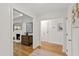 Bright hallway featuring hardwood floors, white walls, and access to various rooms at 4902 Brookhaven Dr, Raleigh, NC 27612