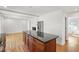 Bright, modern kitchen featuring a large island, stainless steel appliances, and hardwood flooring at 4902 Brookhaven Dr, Raleigh, NC 27612