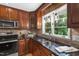 Updated kitchen with stainless steel appliances, dark wood cabinets, and granite countertops at 4902 Brookhaven Dr, Raleigh, NC 27612