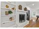 Bright living room with a white brick fireplace and built-in shelves at 4902 Brookhaven Dr, Raleigh, NC 27612