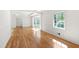 Sun-filled living room features hardwood floors, paneled walls, and a large bay window at 4902 Brookhaven Dr, Raleigh, NC 27612