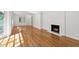 Bright and airy living room with hardwood floors, a fireplace, and ample sunlight at 4902 Brookhaven Dr, Raleigh, NC 27612