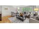 Comfortable living room featuring natural light, hardwood floors, and neutral decor at 4902 Brookhaven Dr, Raleigh, NC 27612