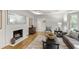 Cozy living room with a fireplace, hardwood floors, and stylish furnishings at 4902 Brookhaven Dr, Raleigh, NC 27612