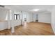 Bright, open living area featuring wood floors, fresh paint, and ample natural light with a glimpse of the kitchen at 4902 Brookhaven Dr, Raleigh, NC 27612