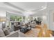 Bright living room with large windows, hardwood floors, and stylish furnishings at 4902 Brookhaven Dr, Raleigh, NC 27612