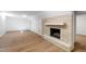 Spacious living area with brick fireplace and wood floors, creating a cozy and inviting atmosphere at 4902 Brookhaven Dr, Raleigh, NC 27612