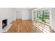Well-lit living room featuring hardwood floors, a fireplace, and a large bay window at 4902 Brookhaven Dr, Raleigh, NC 27612