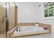 Bright main bathroom with a walk-in shower and soaking tub at 4902 Brookhaven Dr, Raleigh, NC 27612