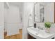 Cozy powder room featuring wainscoting, wood floors and modern fixtures at 4902 Brookhaven Dr, Raleigh, NC 27612
