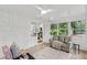 Sunroom with beautiful natural light, brick accent wall, and views of nature at 4902 Brookhaven Dr, Raleigh, NC 27612