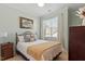 Comfortable bedroom features a decorative bed frame, neutral colored walls, and plenty of natural light at 4924 Amber Clay Ln, Raleigh, NC 27612