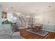 Open dining room featuring decorative rug, hardwood floors, and a small bar with stools at 4924 Amber Clay Ln, Raleigh, NC 27612