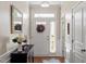Elegant foyer with hardwood floors, decorative mirror, and stylish entry table at 4924 Amber Clay Ln, Raleigh, NC 27612