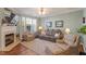 Inviting living room featuring a fireplace, neutral colored walls and hardwood floors at 4924 Amber Clay Ln, Raleigh, NC 27612