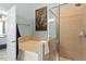 Main bathroom featuring bathtub, shower, blue walls, and neutral tile at 4924 Amber Clay Ln, Raleigh, NC 27612
