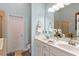 Main bathroom with blue walls, white double sink vanity, and glass enclosed shower at 4924 Amber Clay Ln, Raleigh, NC 27612