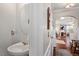 Stylish powder room with a modern round mirror and a unique vessel sink at 4924 Amber Clay Ln, Raleigh, NC 27612