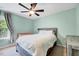 Bedroom with a ceiling fan, window with curtains, crib, bed and dresser at 5016 Silhouette Dr, Durham, NC 27713