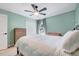 Cozy bedroom features a ceiling fan, white bedding, and neutral walls at 5016 Silhouette Dr, Durham, NC 27713
