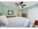 Bedroom with a ceiling fan, bed, dresser, mirror, closet, crib and mint green walls at 5016 Silhouette Dr, Durham, NC 27713