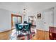Dining room with hardwood floors, a round table and four blue chairs, and backyard access at 5016 Silhouette Dr, Durham, NC 27713