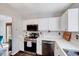 Well-equipped kitchen with white cabinets, modern appliances, and a practical layout at 5016 Silhouette Dr, Durham, NC 27713