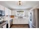 Well-lit kitchen featuring stainless steel appliances, white cabinets, and ample counter space at 5016 Silhouette Dr, Durham, NC 27713