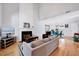 Bright living room with high ceilings, a cozy fireplace, and seamless flow into the dining area at 5016 Silhouette Dr, Durham, NC 27713