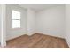 Bright, empty bedroom with hardwood floors, white walls, and a large window offering natural light at 502 Gainer Dr # 2, Raleigh, NC 27610