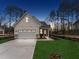 Exterior view of a modern farmhouse style home at twilight with a two-car garage and landscaped front yard at 502 Gainer Dr # 2, Raleigh, NC 27610